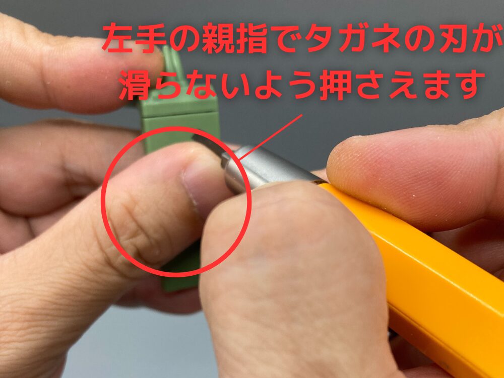 左手の親指でタガネの刃を抑えます。